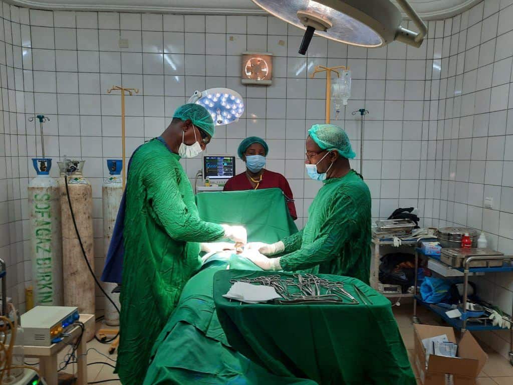 Dr. Itengre (left) performing a surgery.