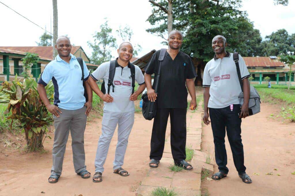 Members of the surgical outreach team at HEAL Africa pose for a photo outside of a healthcare facility.