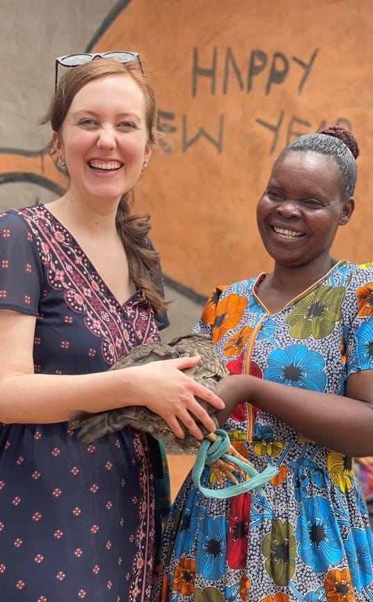 Jesse and Caroline hold a chicken that Caroline gave to Fistula Foundation as a 