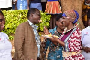 Habiba feeds cake to West Pokot County Governor during a ceremony at Kapenguria County Referral Hospital.