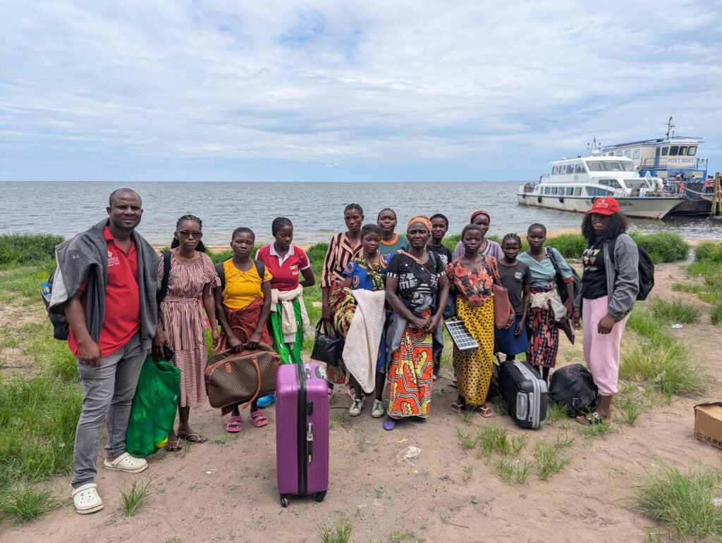 Dr. Royd Nonde, Nurse Mary Zulu, and 12 fistula patients pose together after traveling by boat to receive treatment at Mansa General Hospital