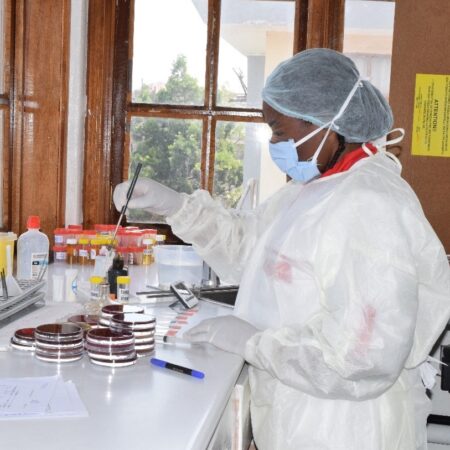 A medical professional performs laboratory tests